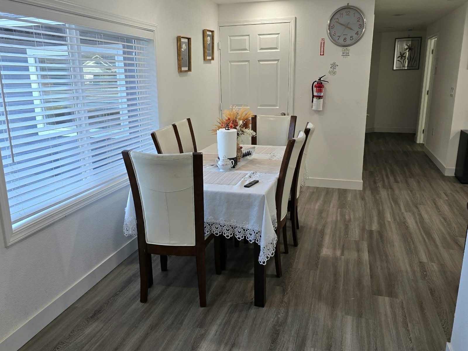 Tevah dining room with a table and chairs beside a window