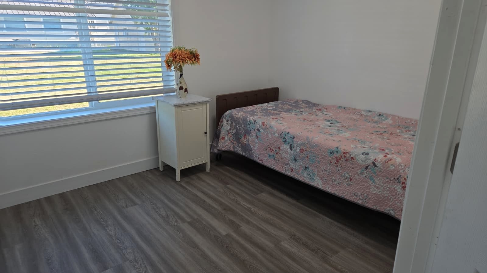 Tevah bedroom with a bed beside a window